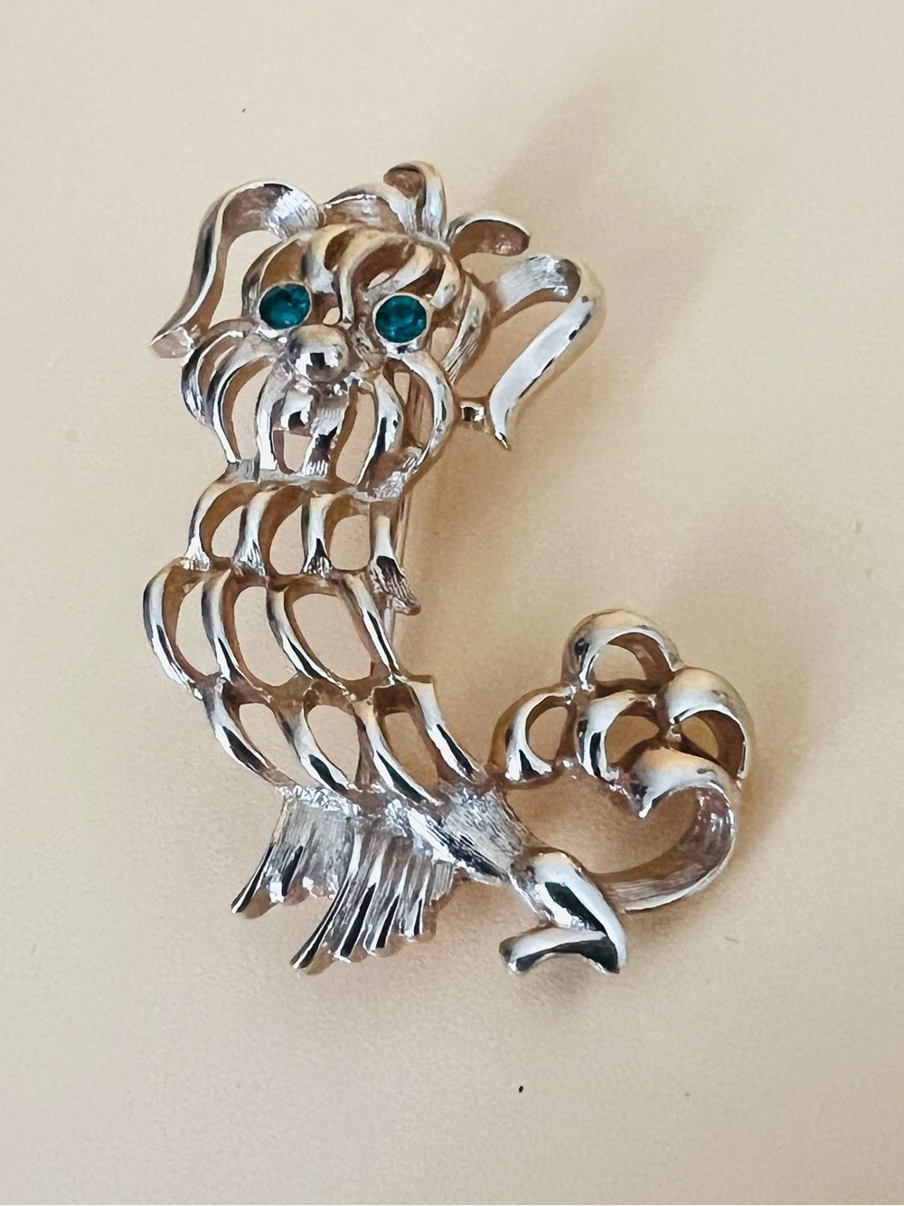 Vintage gold tone Avon dog brooch with green eyes stamped